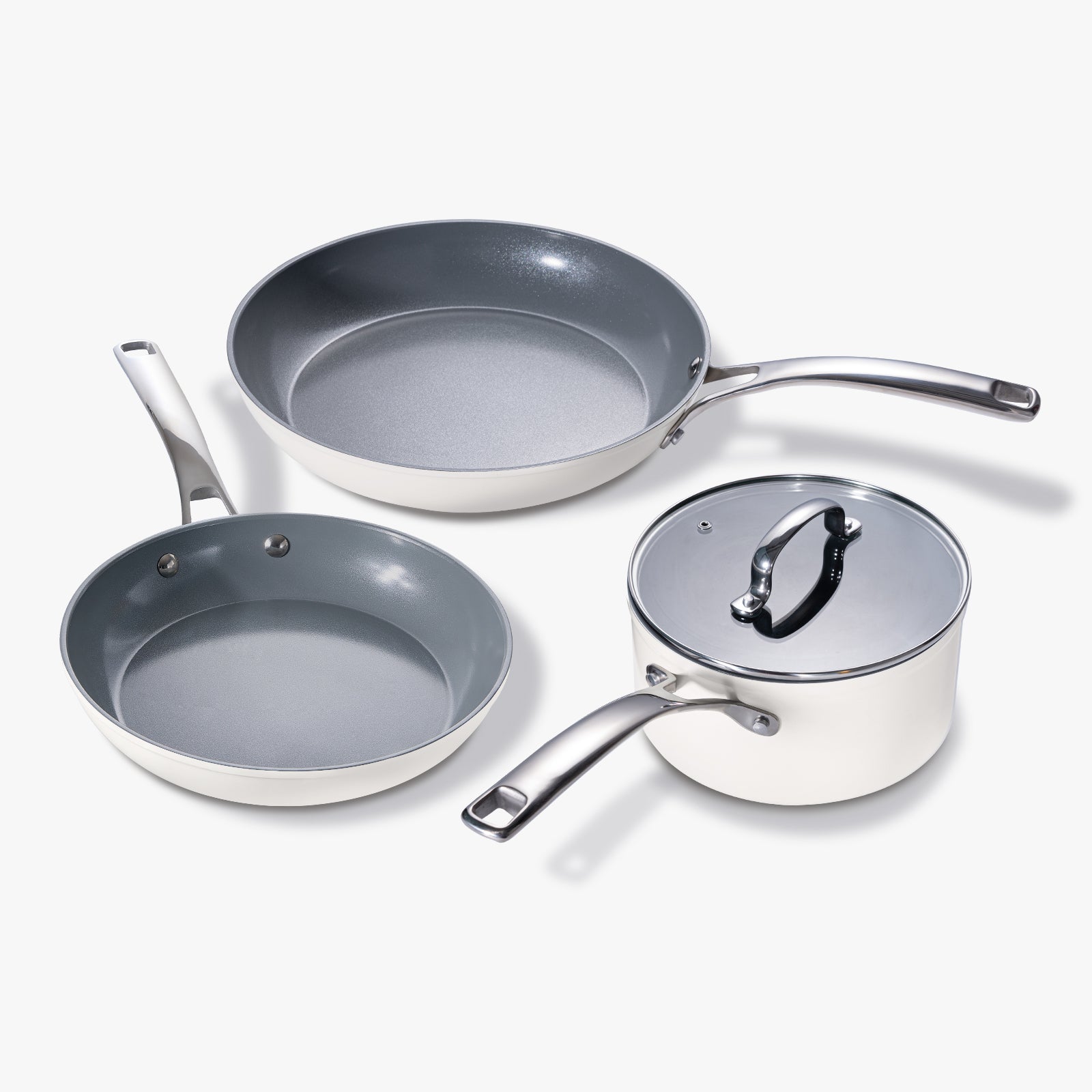 A 4-piece cookware set including pots with lids, pans with handles, in white and gray colors, with a nonstick surface.